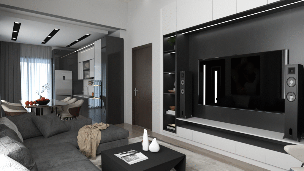 Salon ve Mutfak İç Mimari Tasarımları çık konsept bir dairede, gri koltuk takımı ve siyah orta sehpa. Arka planda mutfak ve yemek alanı görülüyor.