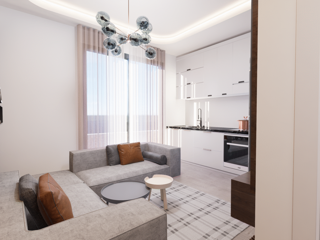 Salon ve Mutfak İç Mimari Tasarımları Doğal ışık alan modern salon-mutfak tasarımı. Geniş bir cam kapı ve tül perdelerin önünde gri köşe koltuk yer alırken, sağda beyaz ve siyah mermer tezgahlı minimalist bir mutfak alanı yer alıyor